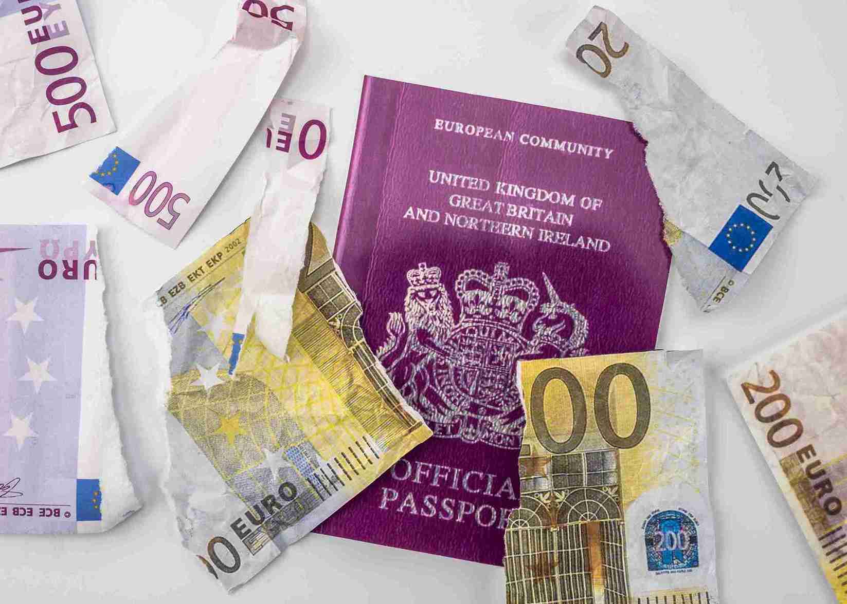 British passport next to broken euro notes europe.