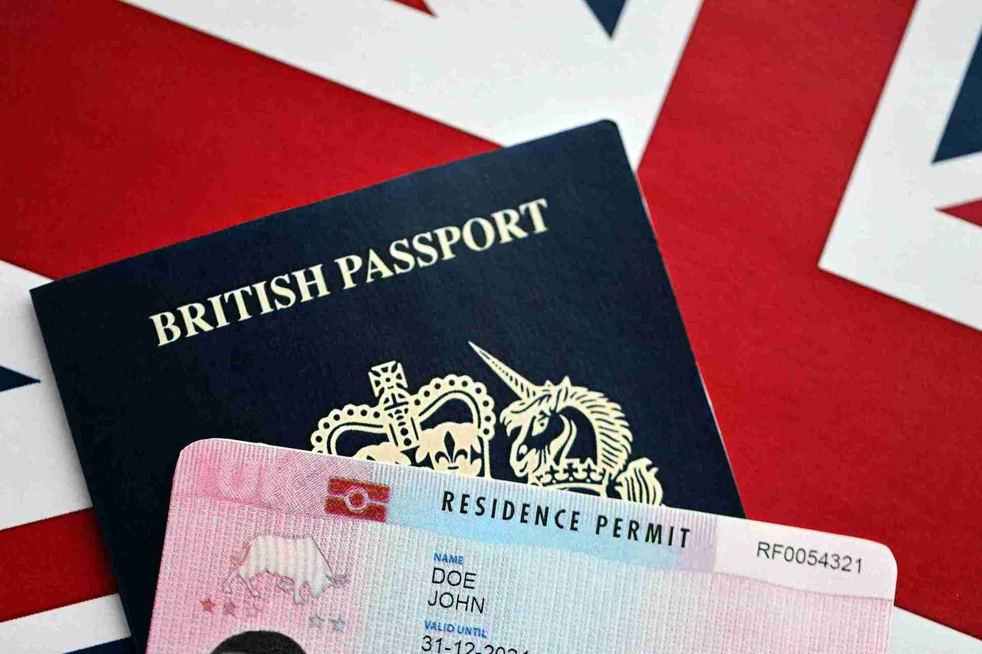 British passport with residence permit on union flag.