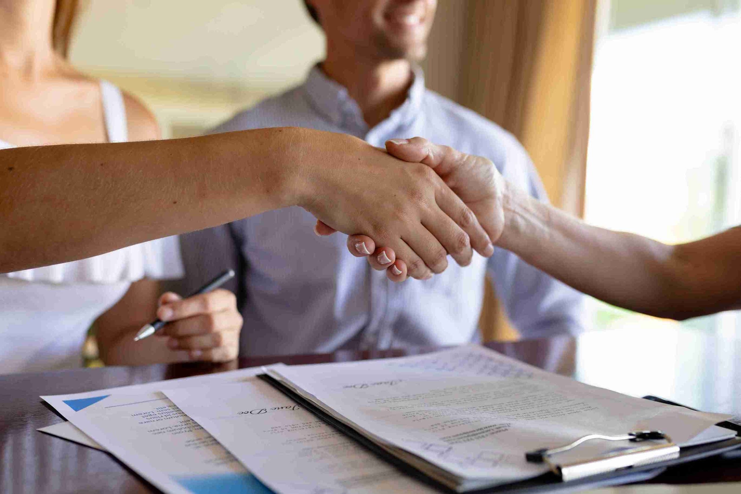 Business agreement with a handshake indoors.