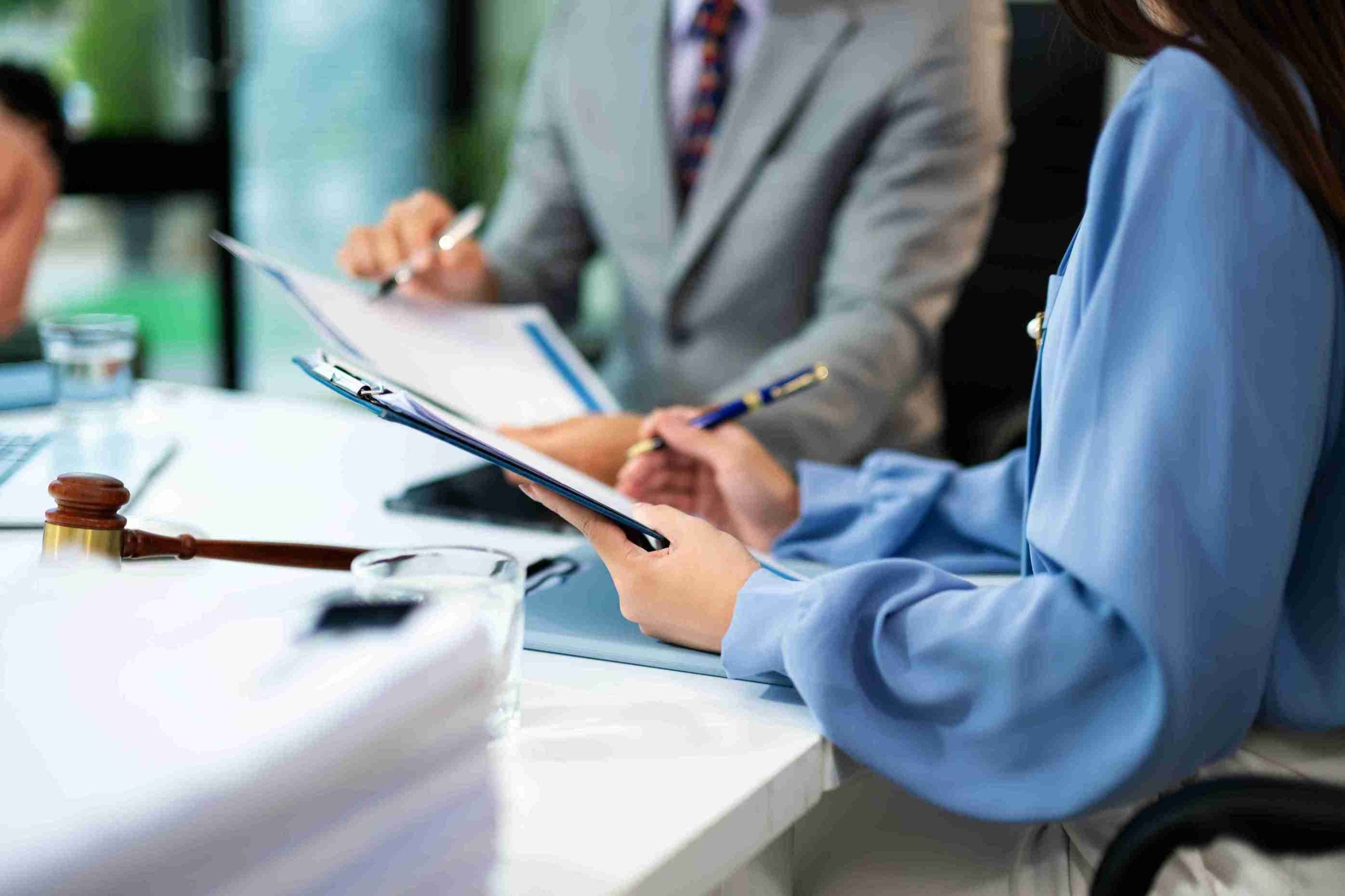 Business and lawyers discussing contract papers.