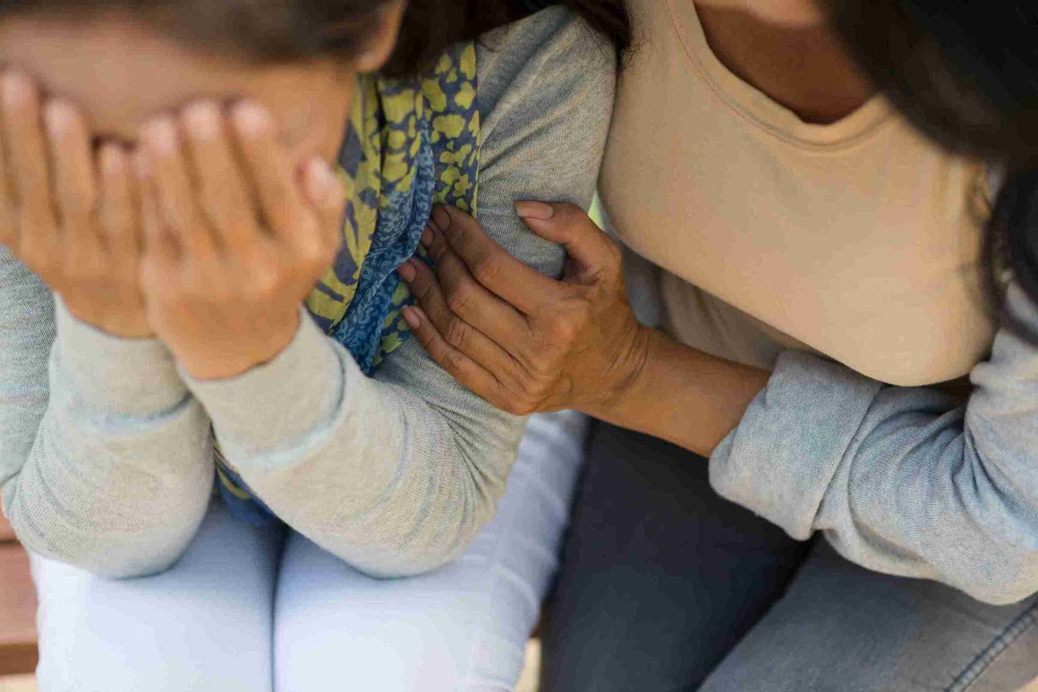 Comfort touch woman supporting a friend who is victim of asult.