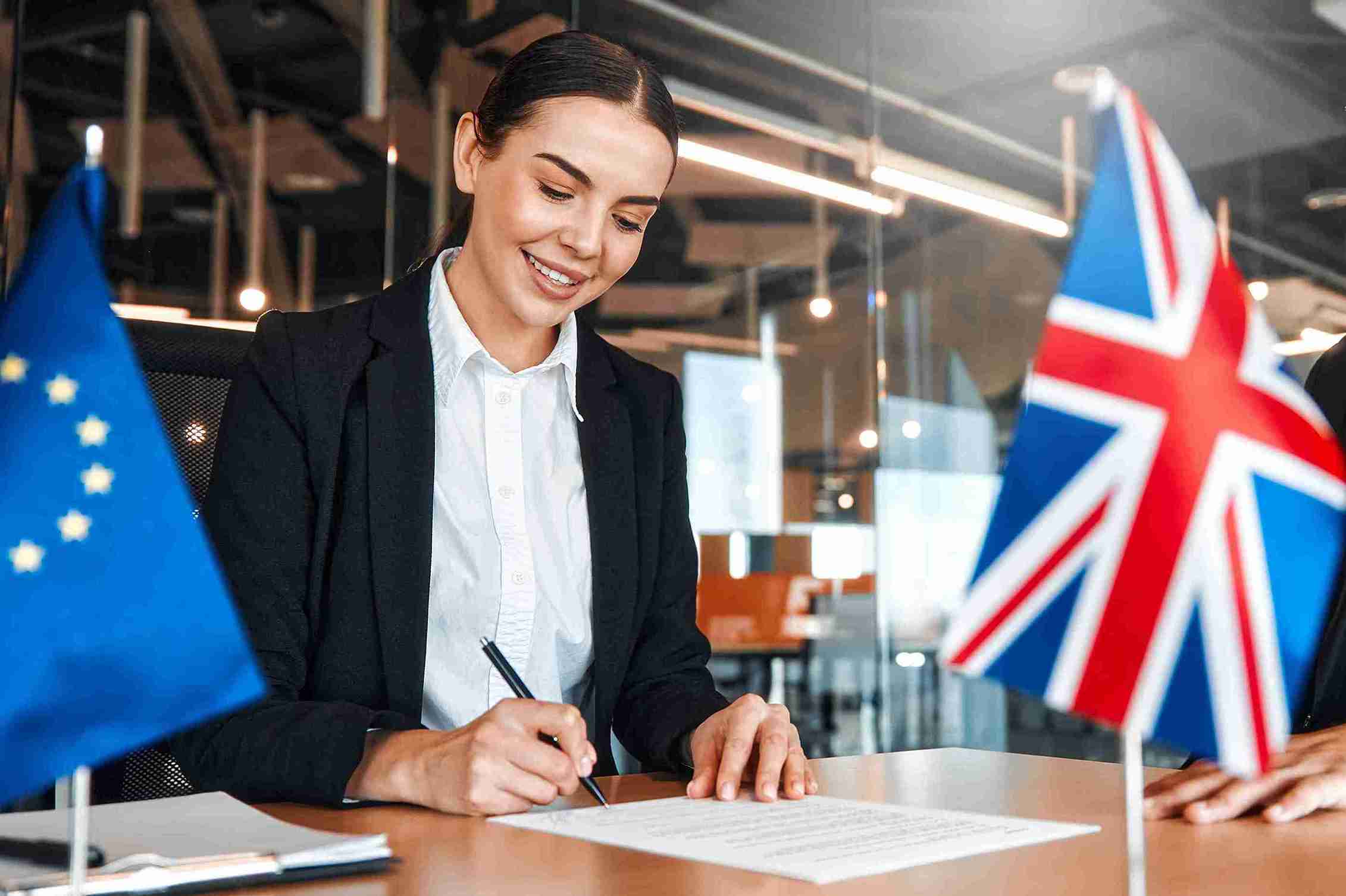 A young women signing a paper.