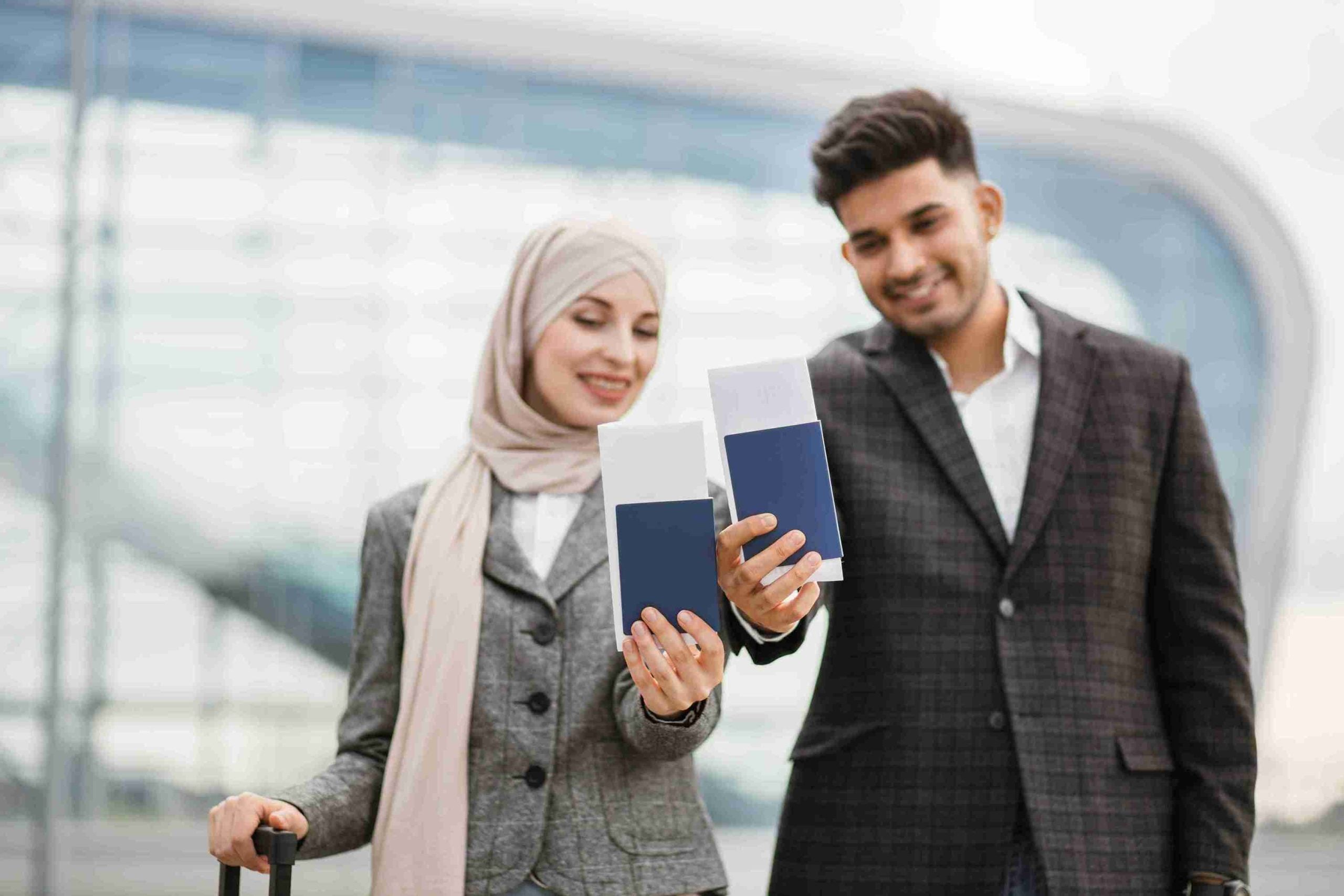 Couple posing on camera outside airport.