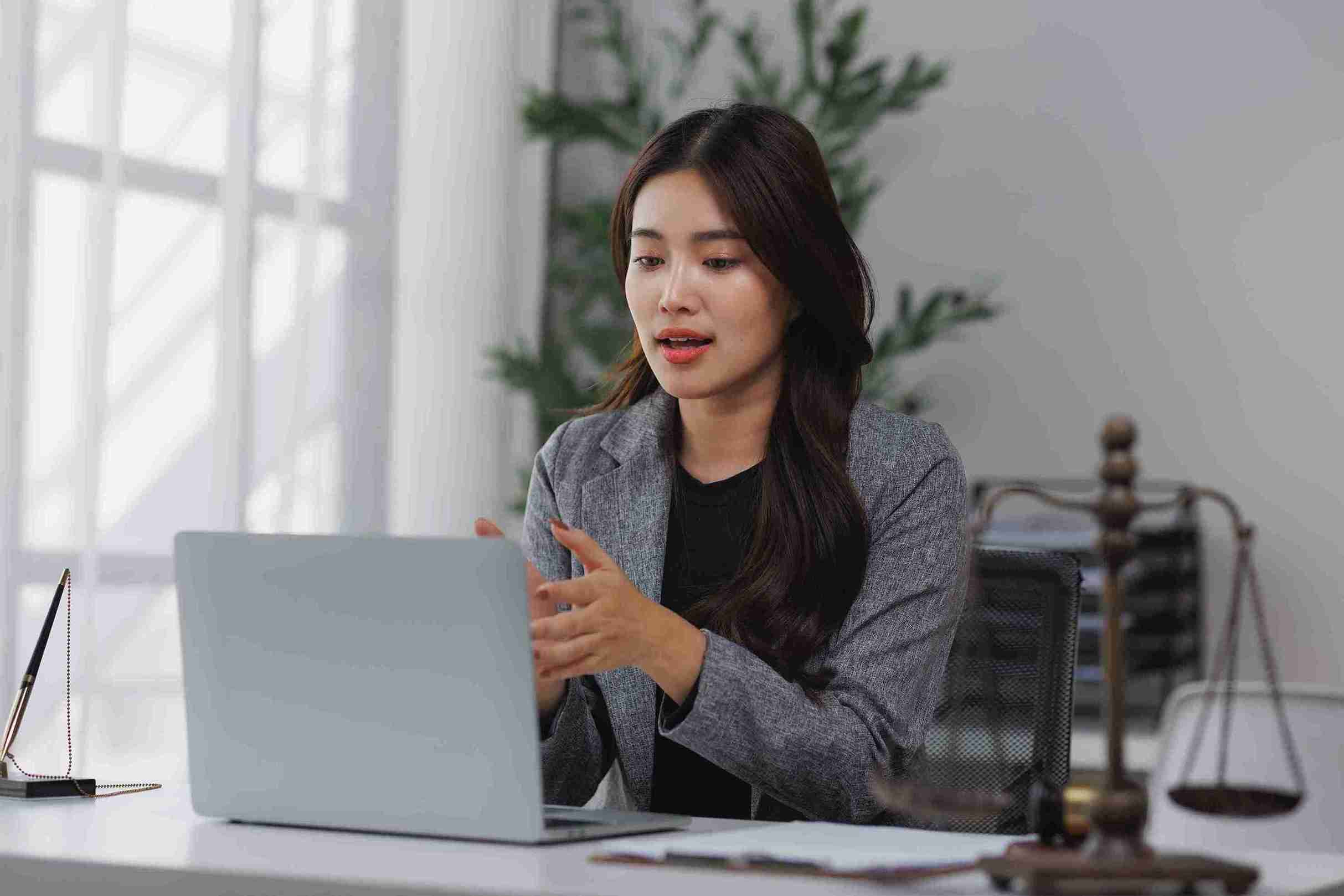 A women is writing some thing on laptop.