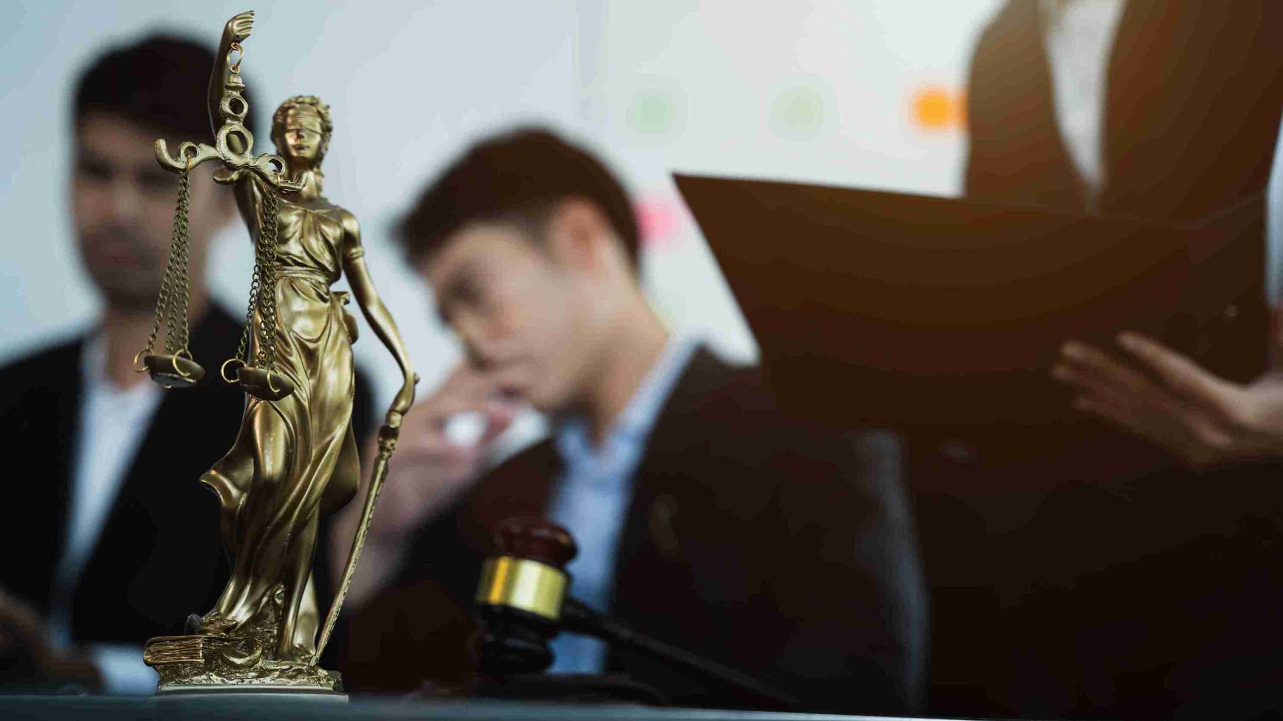 Statue of justice with scales and auction hammer.