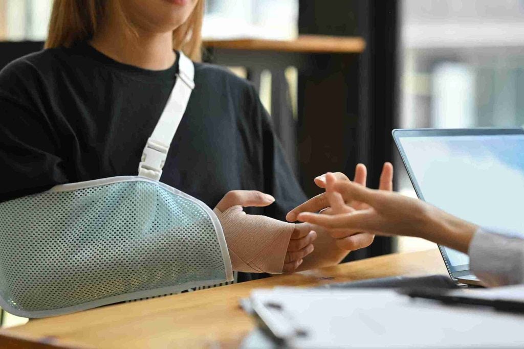 Women with sling consulting with professional.