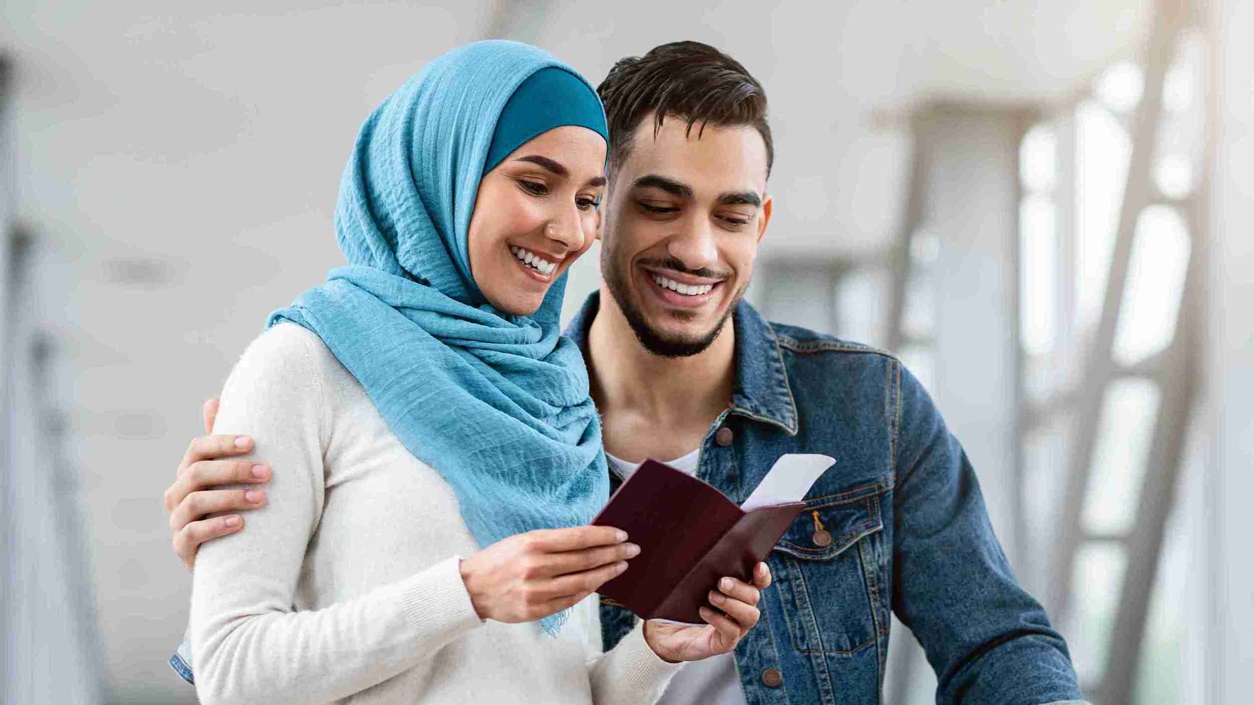Couple cheering and smiling on approval of their visa.
